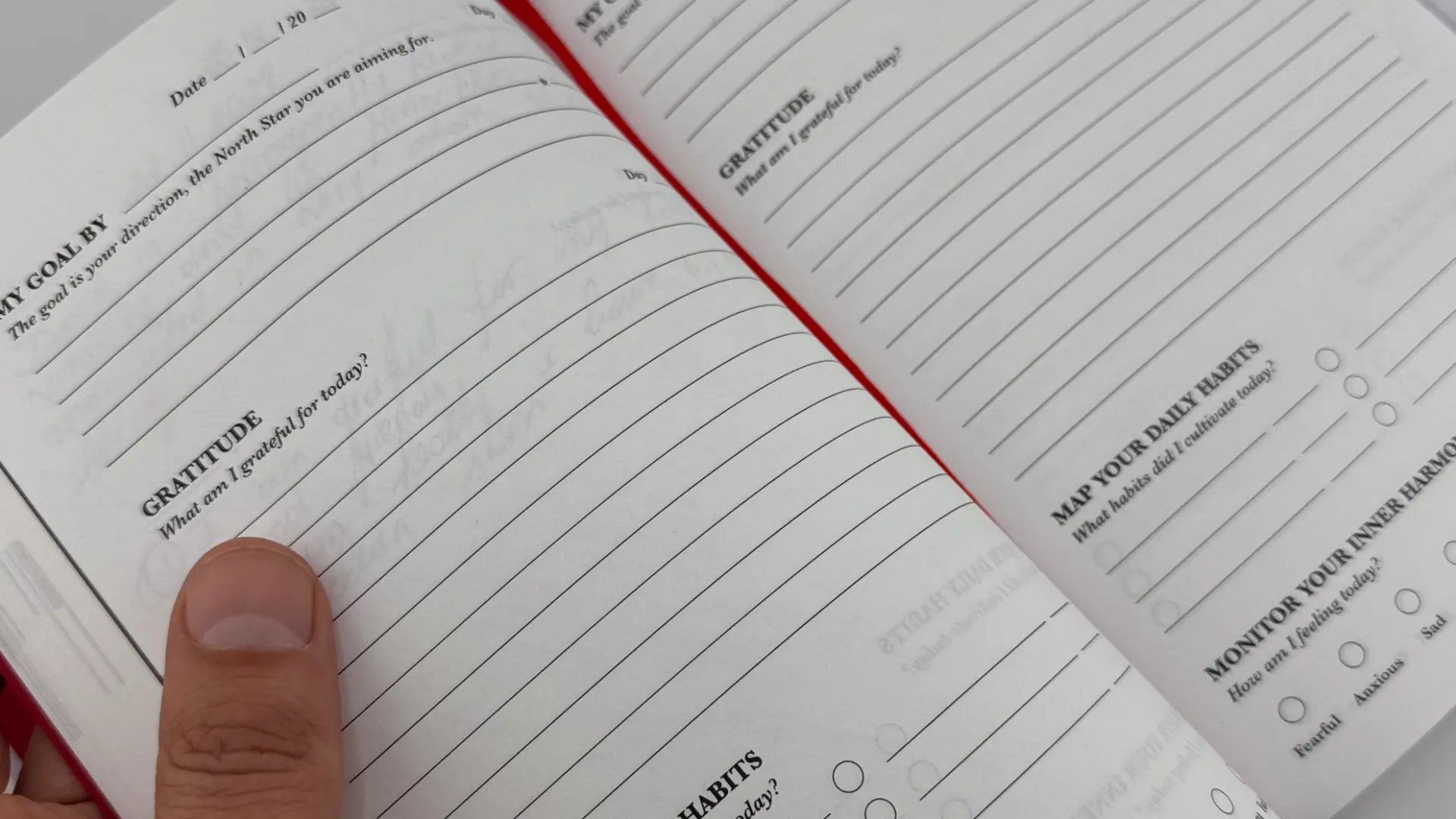 iAmEvolving Journal on a desk beside a pen and notebook, representing goal setting and planning