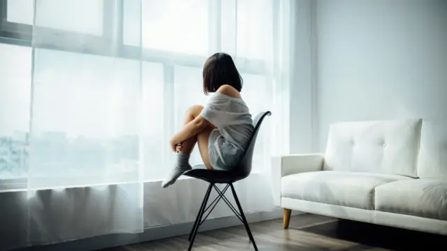 Person journaling in a calm space to ease anxiety and support emotional wellbeing.