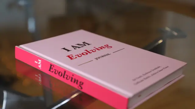 iAmEvolving Journal on a desk, part of a daily journaling habit routine.