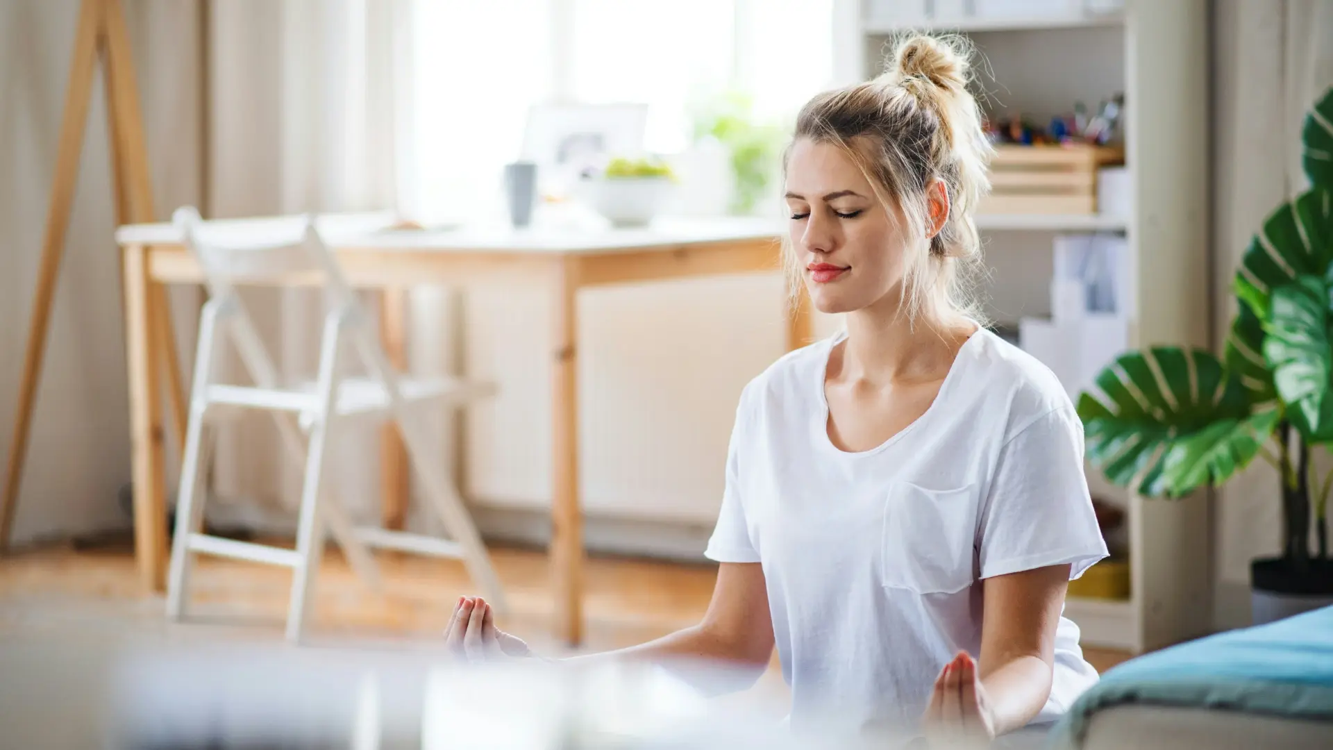 Woman practicing mindful breathing meditation at home to embrace calm and inner peace