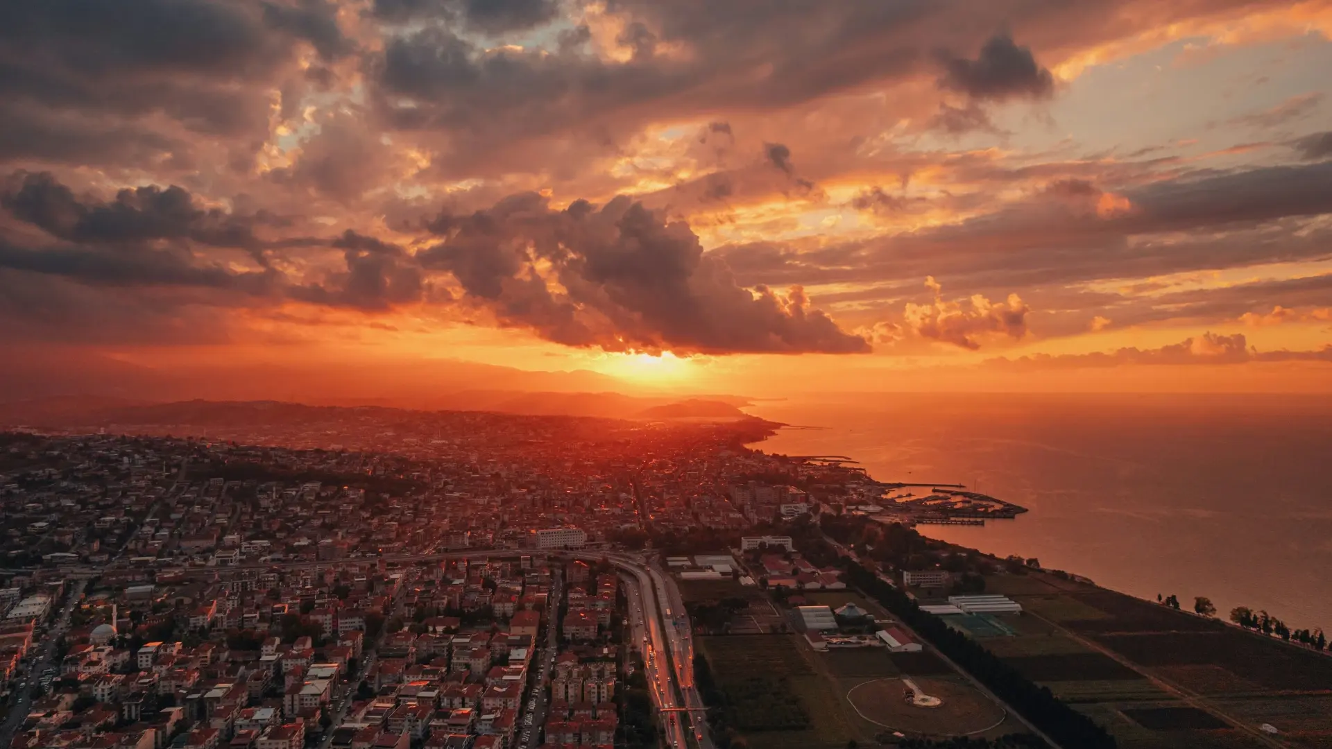 Sunrise over a calm city skyline symbolizing a new day and a mindset shift through reflection and journaling.