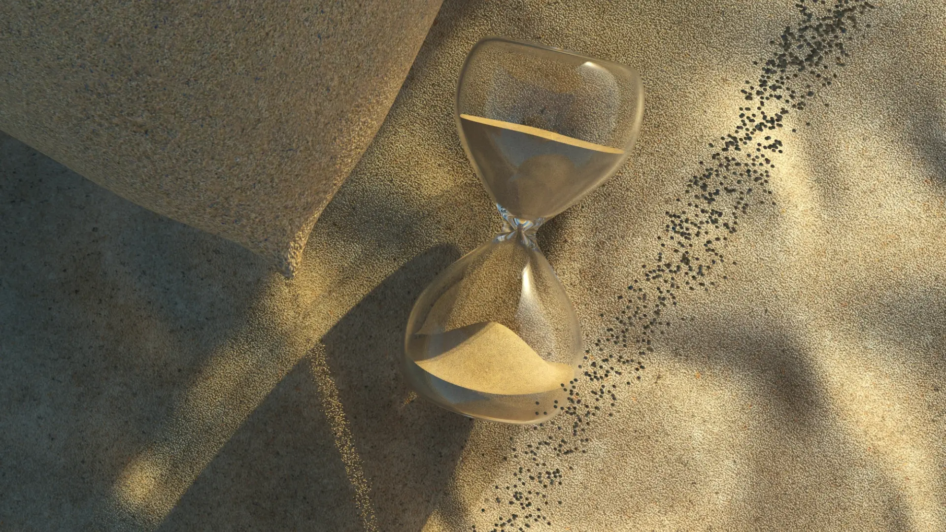 A glass hourglass resting on sand in warm sunlight, symbolizing patience, timing, and the natural process of growth.