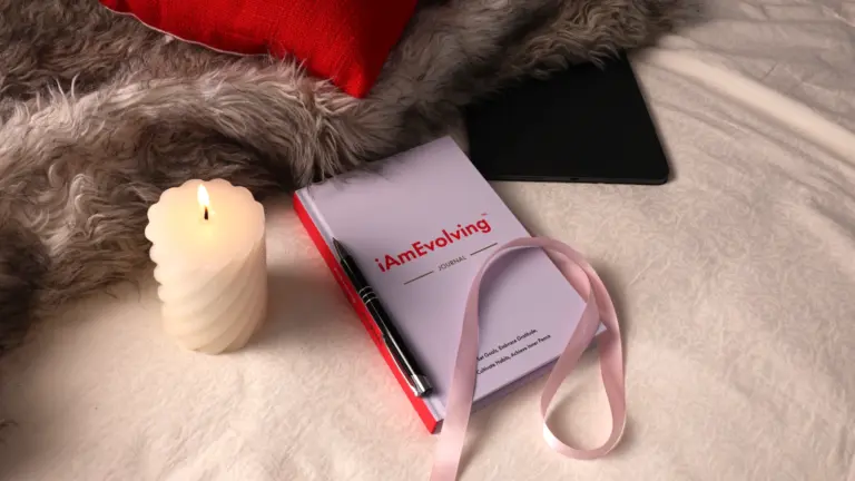 Candle-lit iAmEvolving Journal on a cozy evening setting — symbolizing mindful gratitude rituals and reflection.