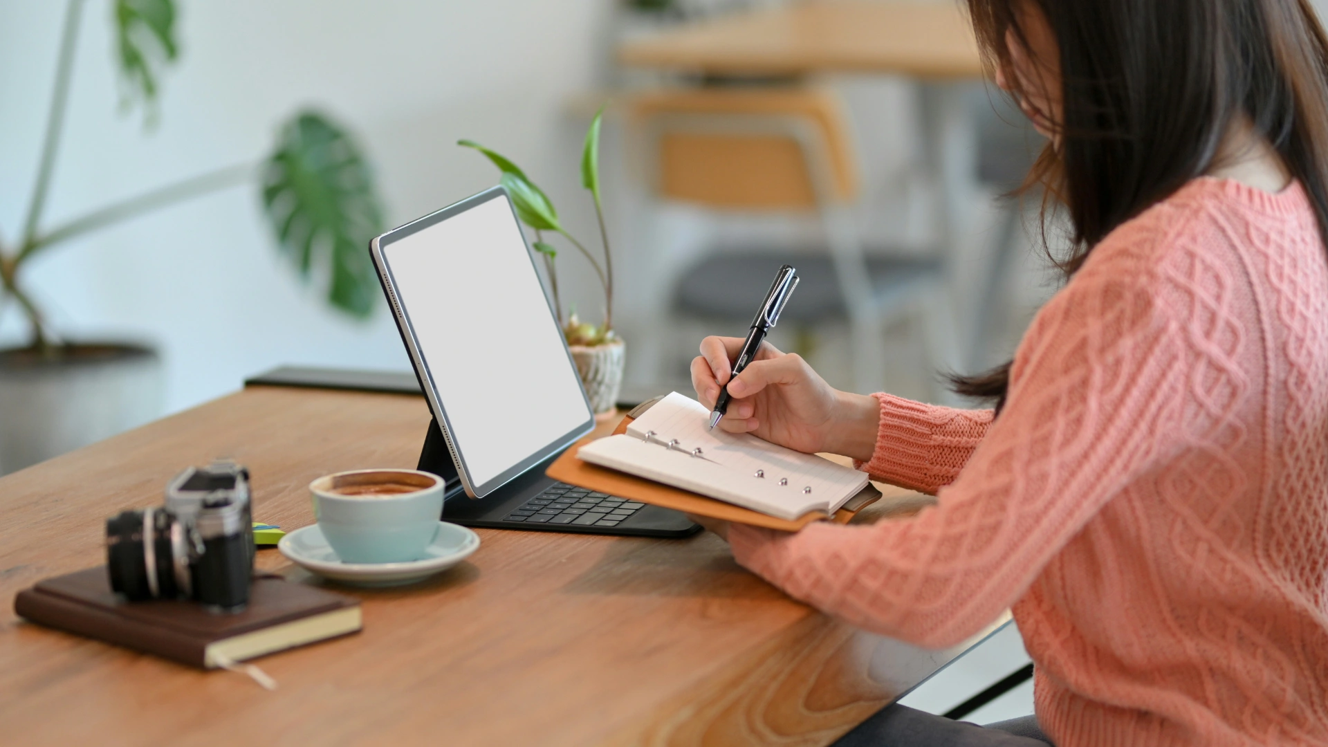 A woman journaling mindfully with coffee and natural light, symbolizing awareness and daily reflection.