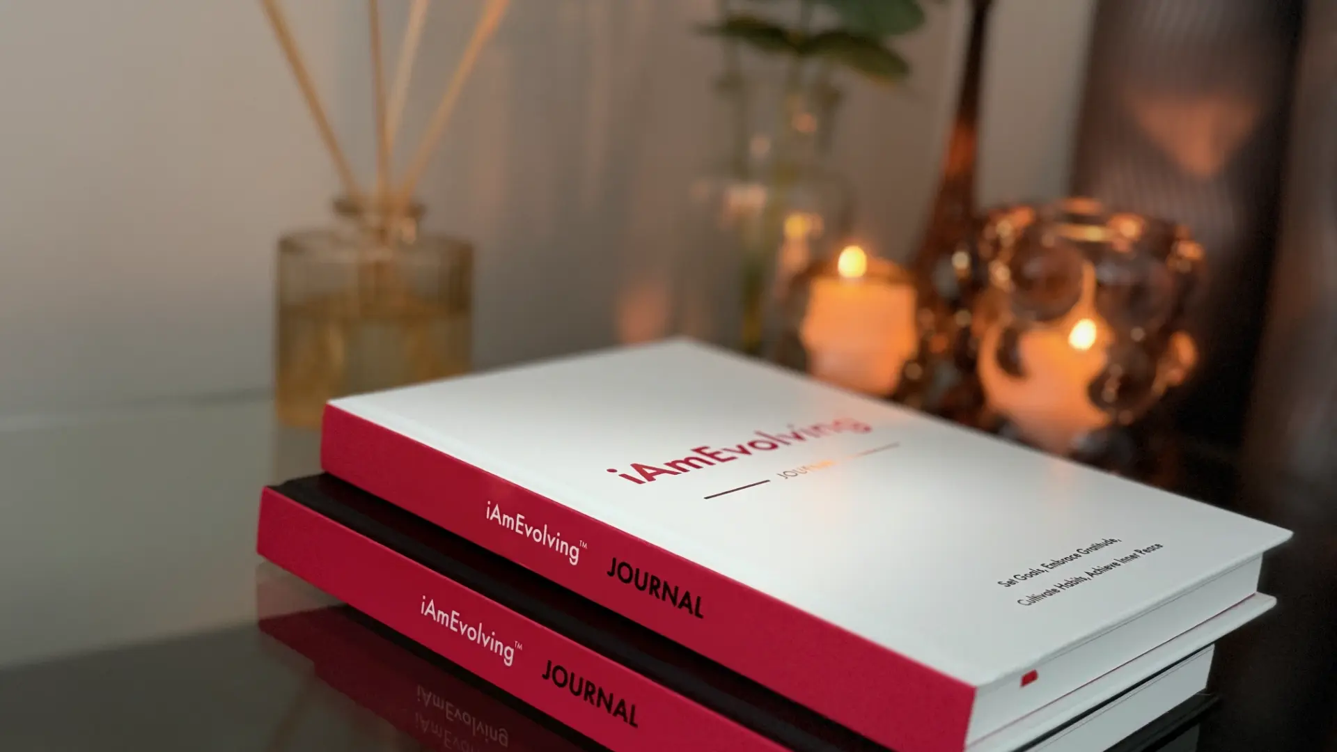 iAmEvolving Journal with candlelight on a desk — a calm New Year reflection and intention-setting moment.
