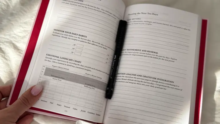 Open guided journal with daily prompts and emotional tracking chart on a cozy morning setup.