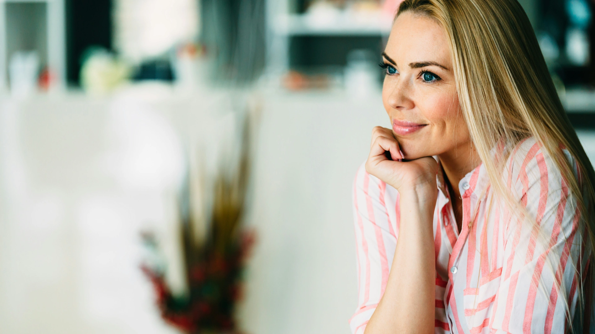 Woman smiling thoughtfully in natural light, symbolizing clarity, self-alignment, and living with purpose.