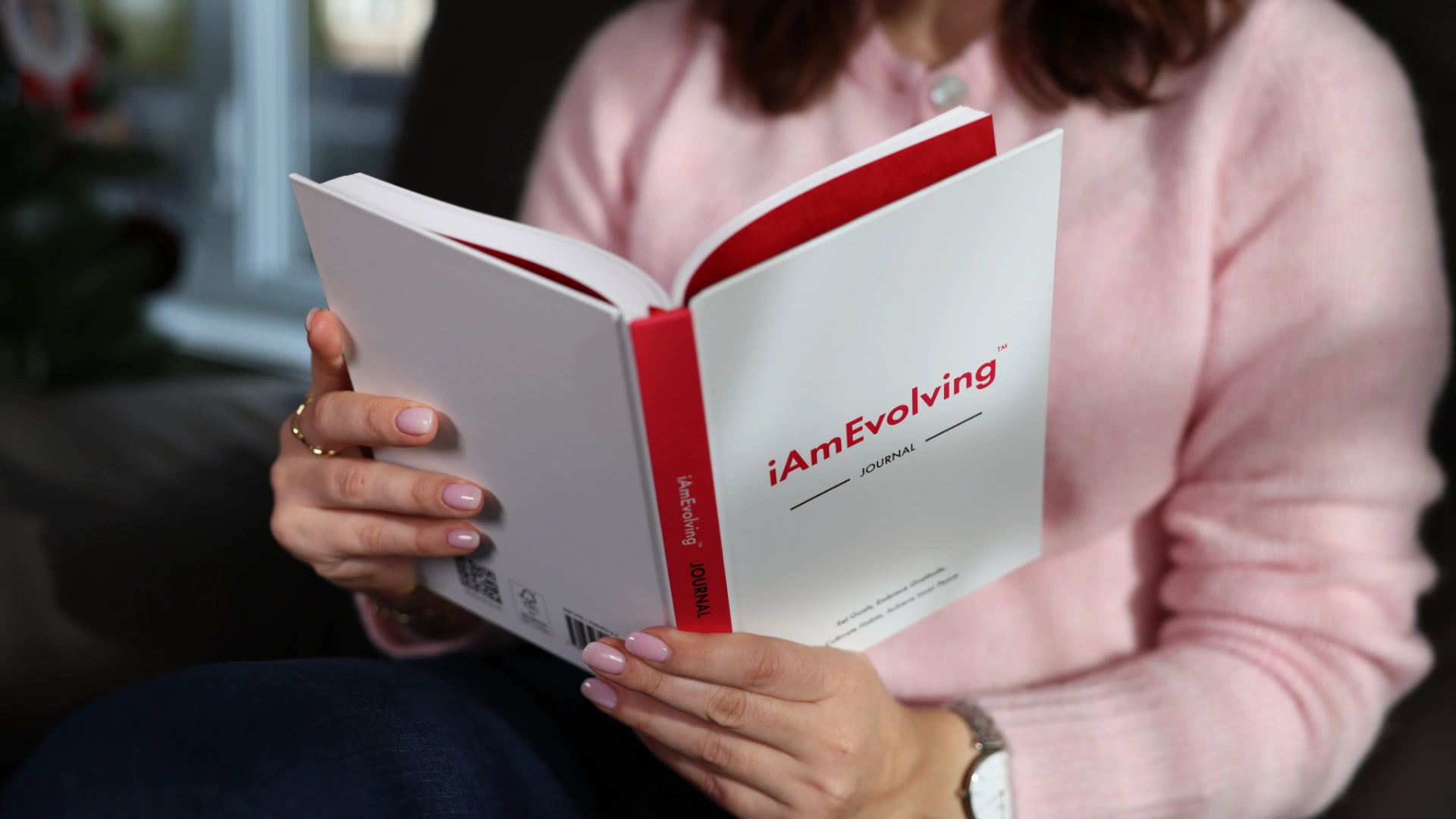 Close-up of a person reading the iAmEvolving Journal, symbolizing reflection, learning, and continuous personal evolution.