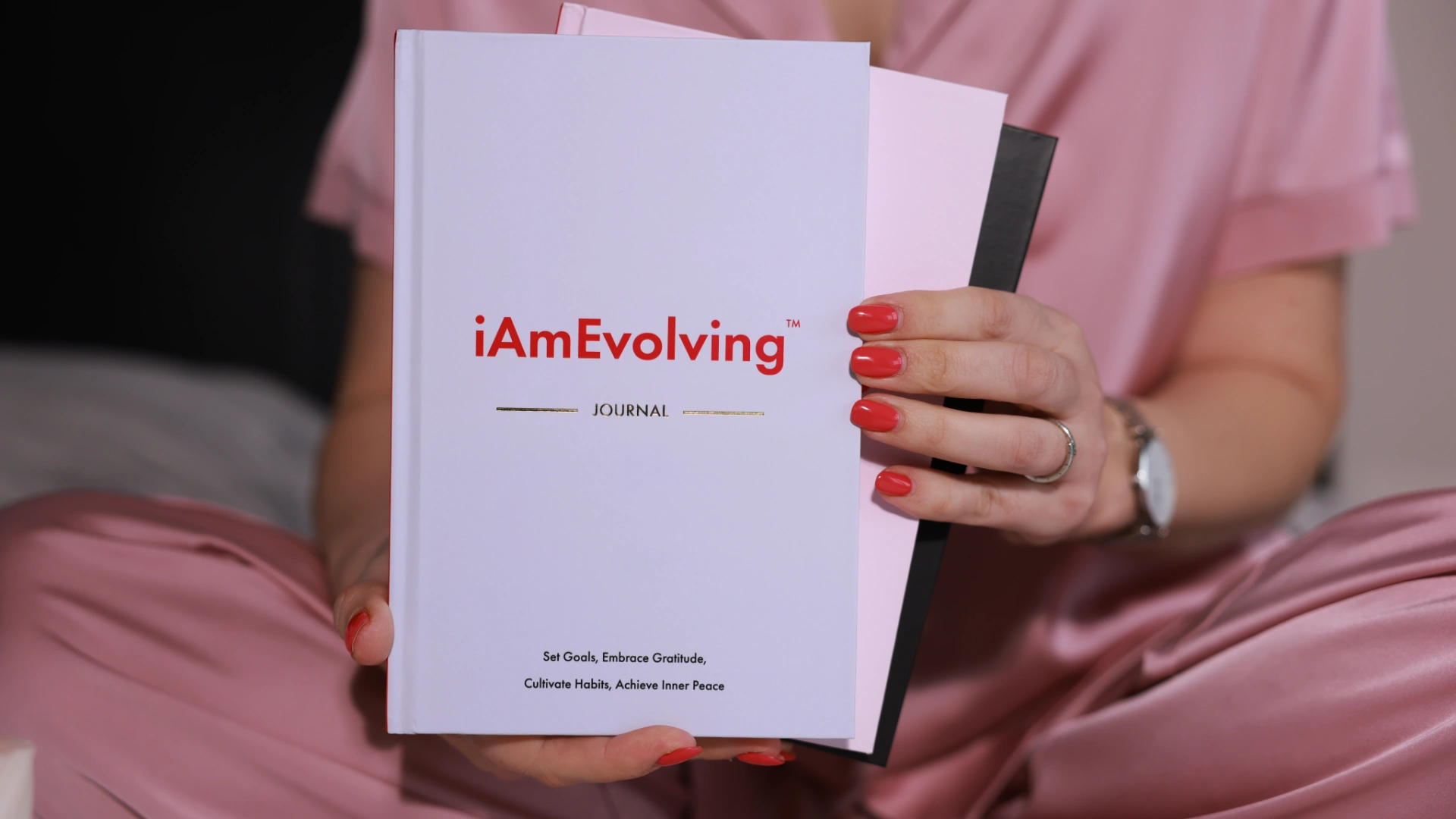 iAmEvolving Journal white cover held in hands — best affirmation journals guide