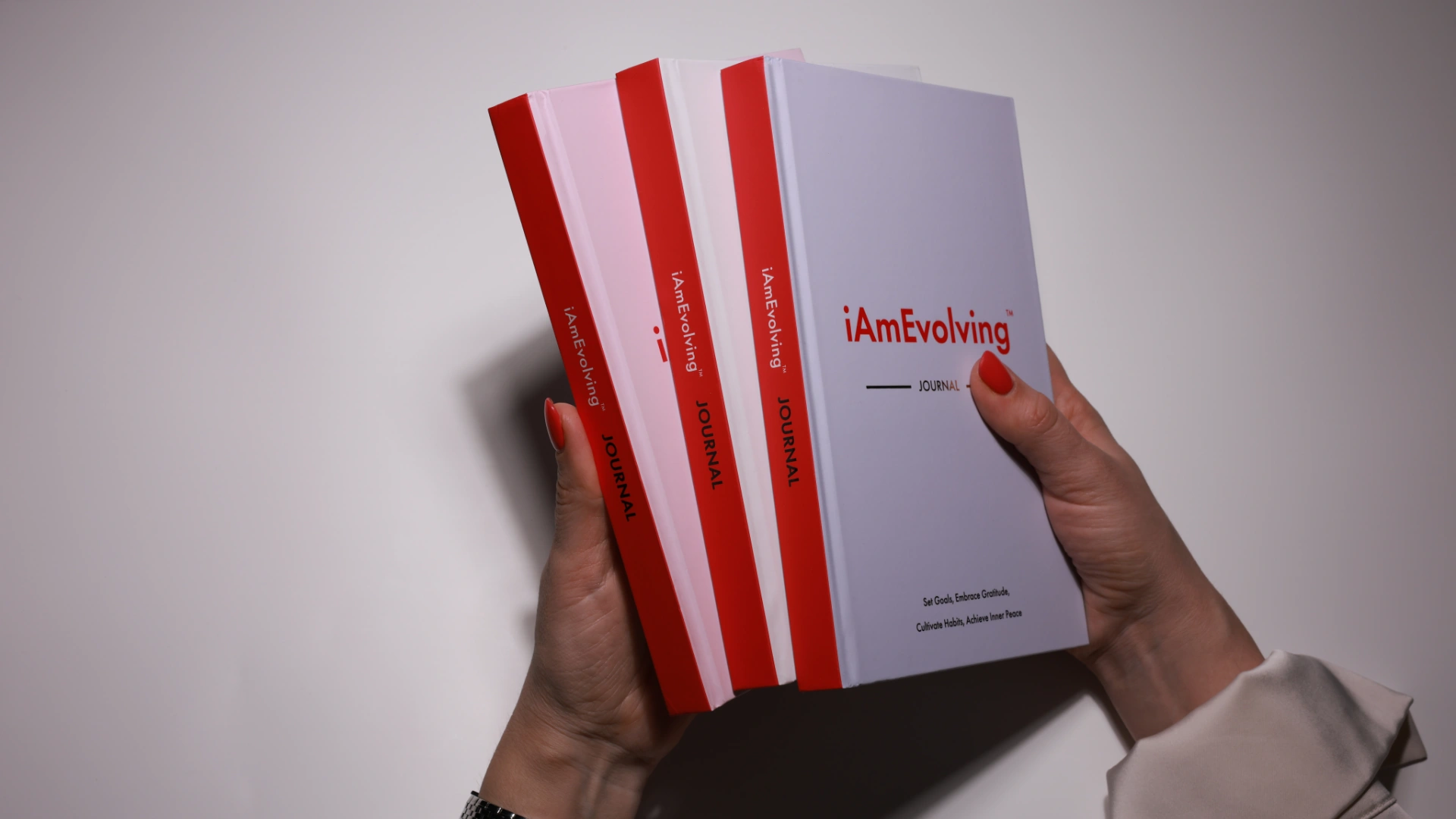 iAmEvolving Journal three covers fanned — best gratitude journals guide