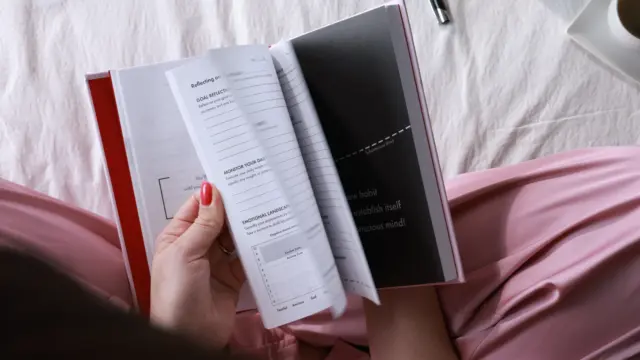 iAmEvolving Journal open showing daily prompts — best habit tracker journals guide