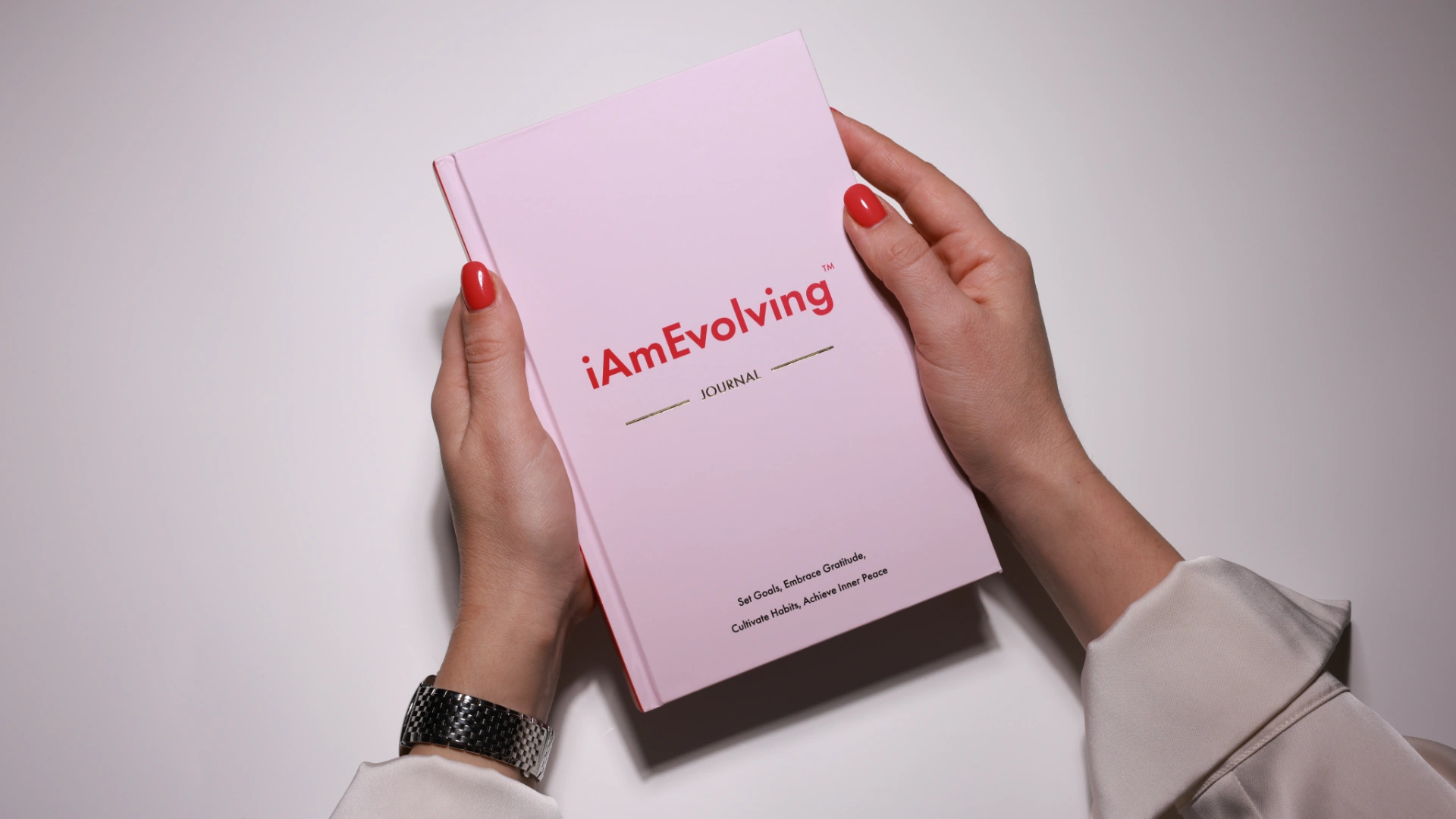 iAmEvolving Journal rose cover held in hands — best journals for beginners guide