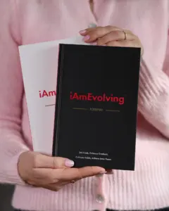 Woman holding iAmEvolving Journals in black and white